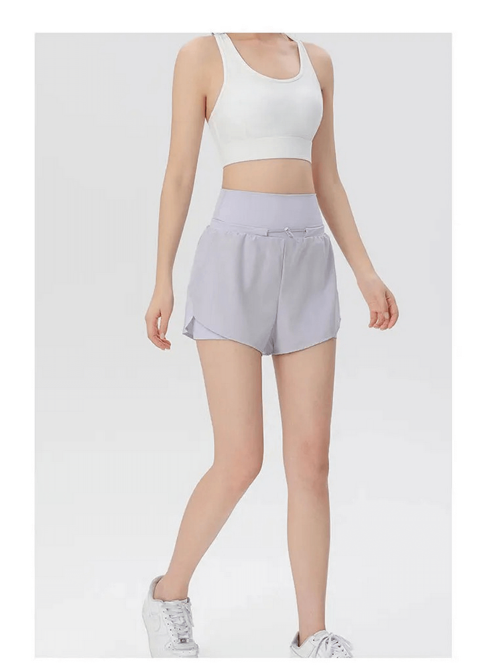 Woman wearing high waist athletic shorts in light purple, perfect for gym and warm weather, polyester-spandex blend.